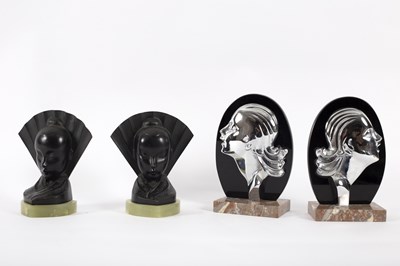 Lot 102 - A pair of onyx and black metal bookends in the...
