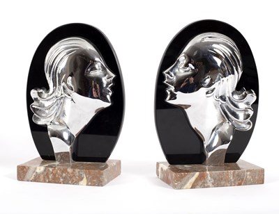 Lot 102 - A pair of onyx and black metal bookends in the...