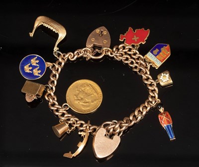 Lot 31 - A charm bracelet, the 9ct curb-link bracelet...