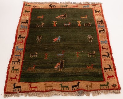 Lot 584 - A Persian Gabbeh rug, central dark green field...