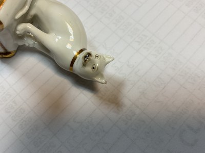 Lot 611 - A rare Rockingham porcelain miniature model of a cat