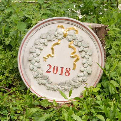 Lot 535 - A composition stone roundel dated 2018