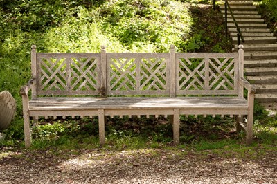 Lot 536 - A weathered teak garden seat