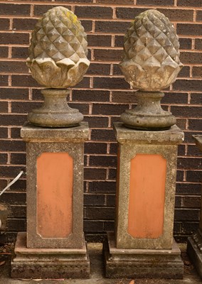 Lot 541 - A pair of composition stone pineapple finials