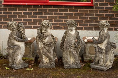 Lot 546 - A set of four composition stone figures of putti