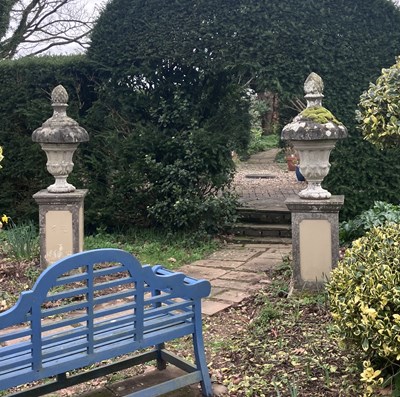Lot 557 - A pair of composition stone urns
