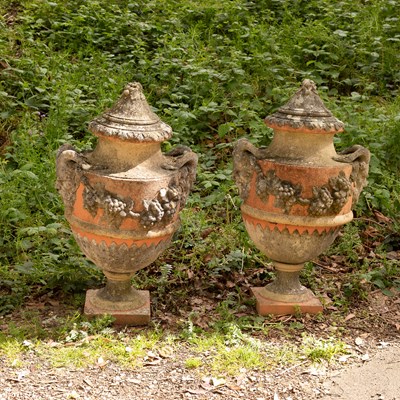 Lot 571 - A pair of composition stone urns