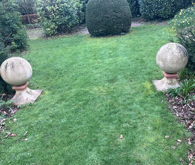 Lot 573 - A pair of composition stone ball finials