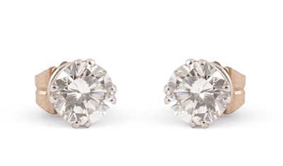 Lot An impressive pair of diamond single stone stud earrings